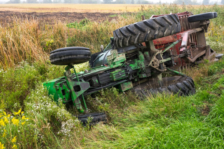 A tractor and cart from a local farm lay in a ditch after rolling off a road in Ontario Canada.