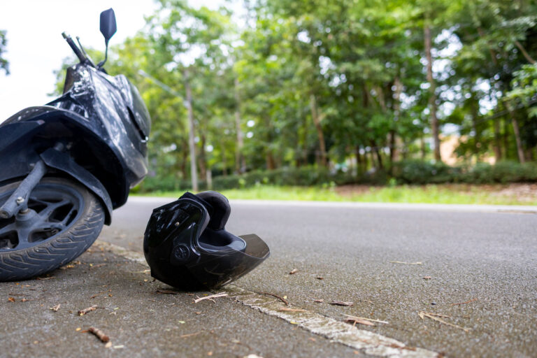 Motorcycle accident with helmet on road and safety reminder Save Life message, concept of road safety and awareness