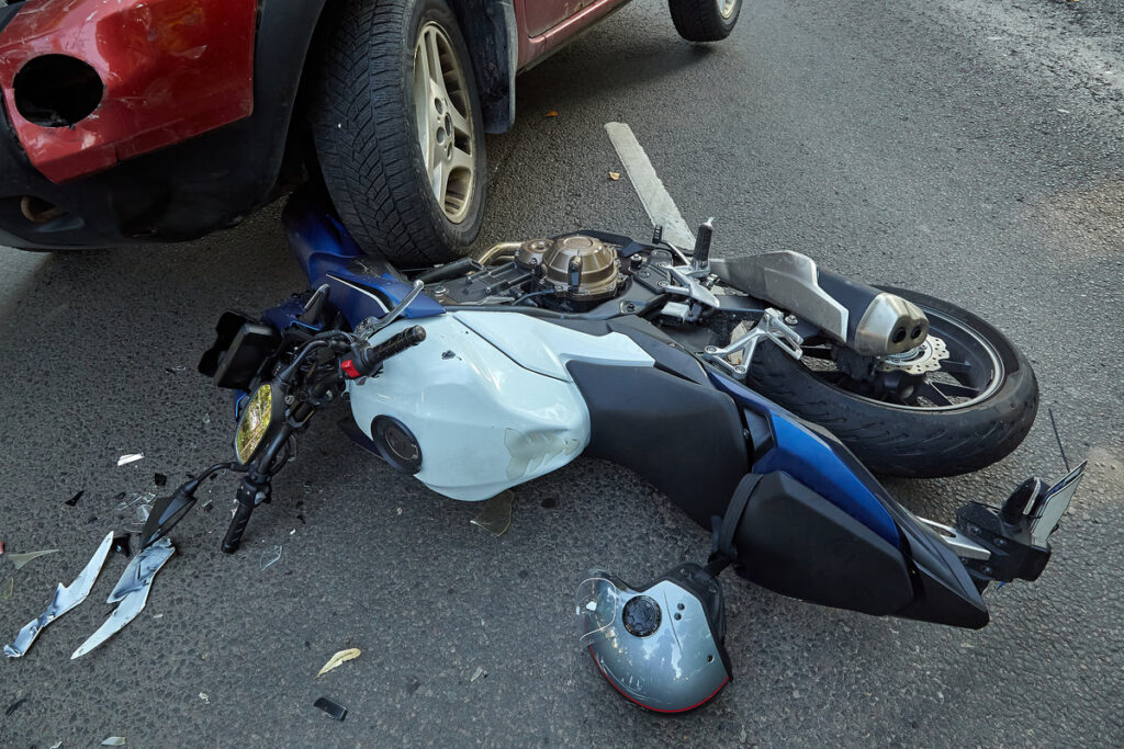 September 13, 2023, Riga, Latvia, damaged car and motorbike on the city road at the scene of an accident because of non-observance of distance