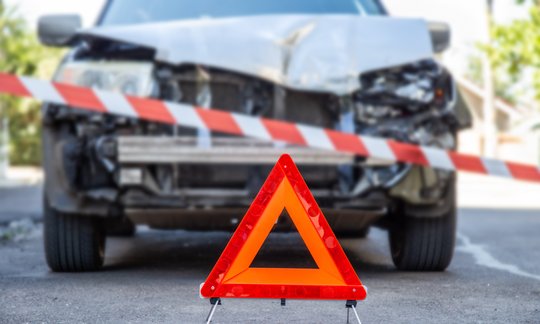 Two cars involved in a minor fender bender collision on a Texas road